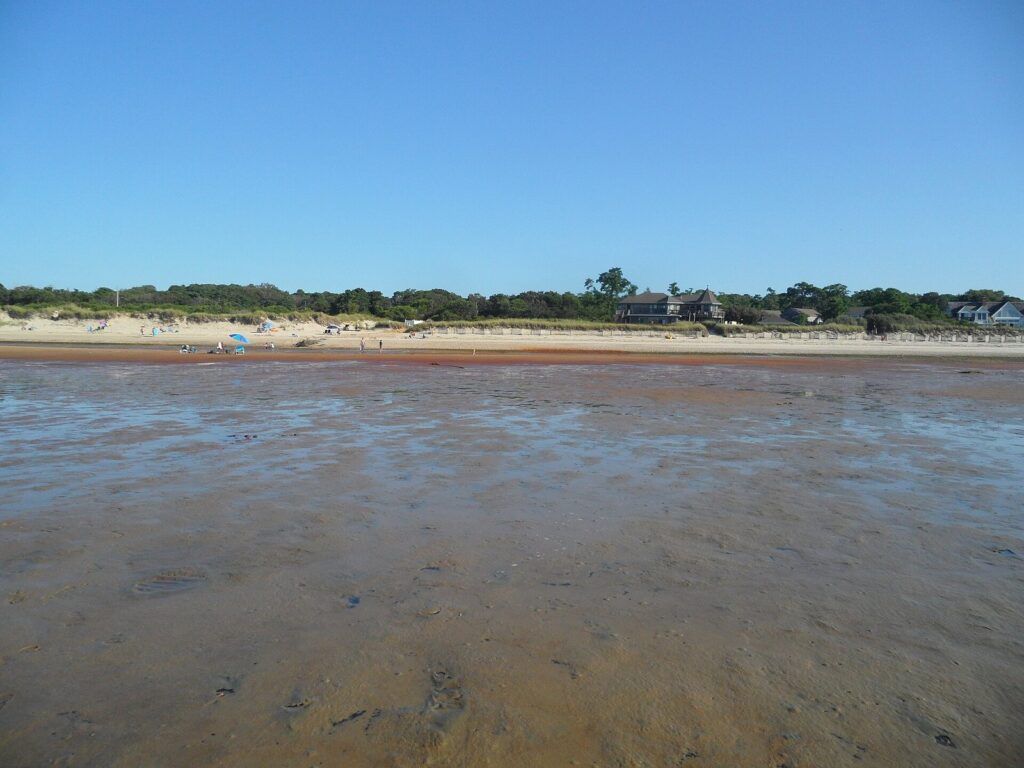 Wet sand flats stretching far out from a Brewster beach at low tide on Cape Cod Bay