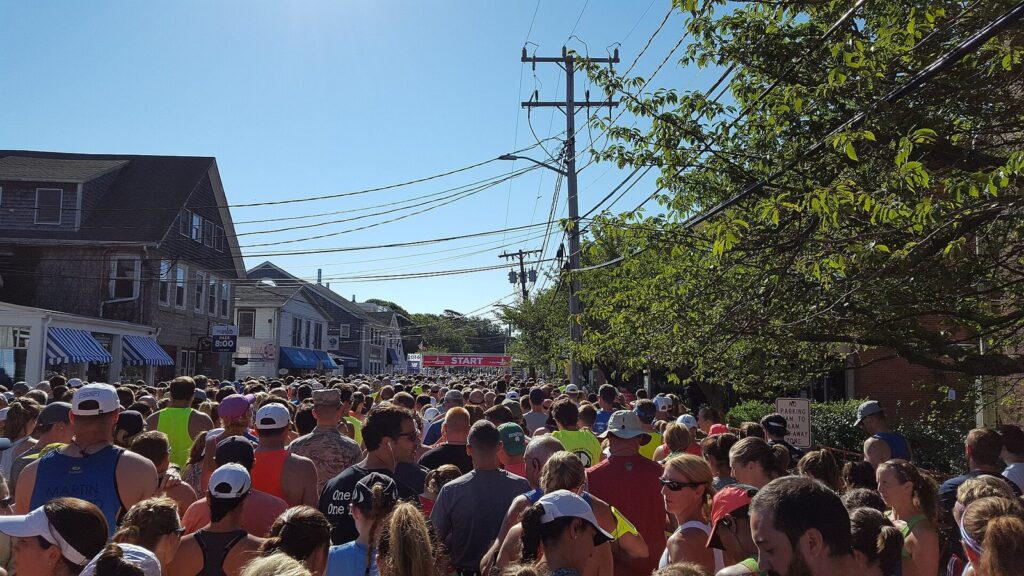 Thousands of runners packed onto a village street at the start line of the Falmouth Road Race in Woods Hole