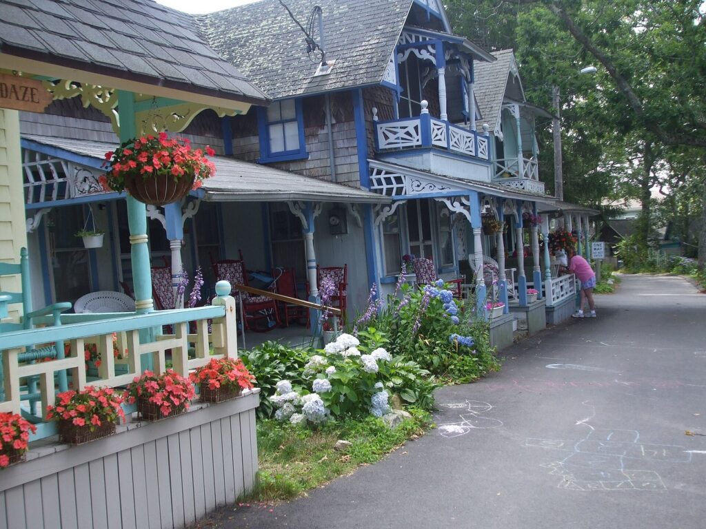 Brightly painted gingerbread cottages with flower boxes and lacy trim along a lane in Oak Bluffs