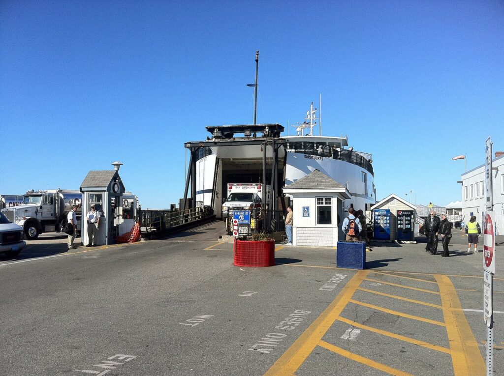 A Steamship Authority ferry loading vehicles through its open bow at the Woods Hole terminal